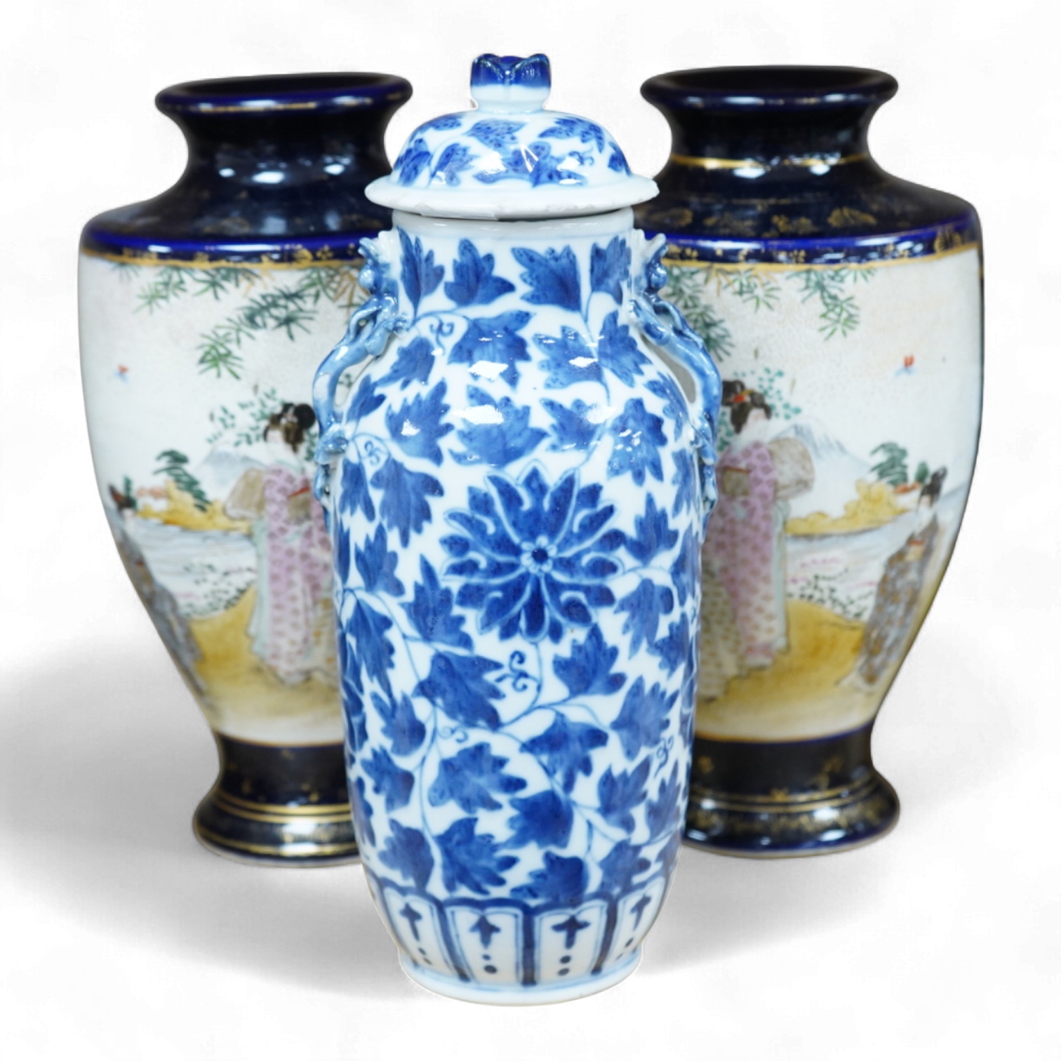 A late 19th century Chinese blue and white vase and cover and two Japanese Satsuma pottery vases, largest 24cm high